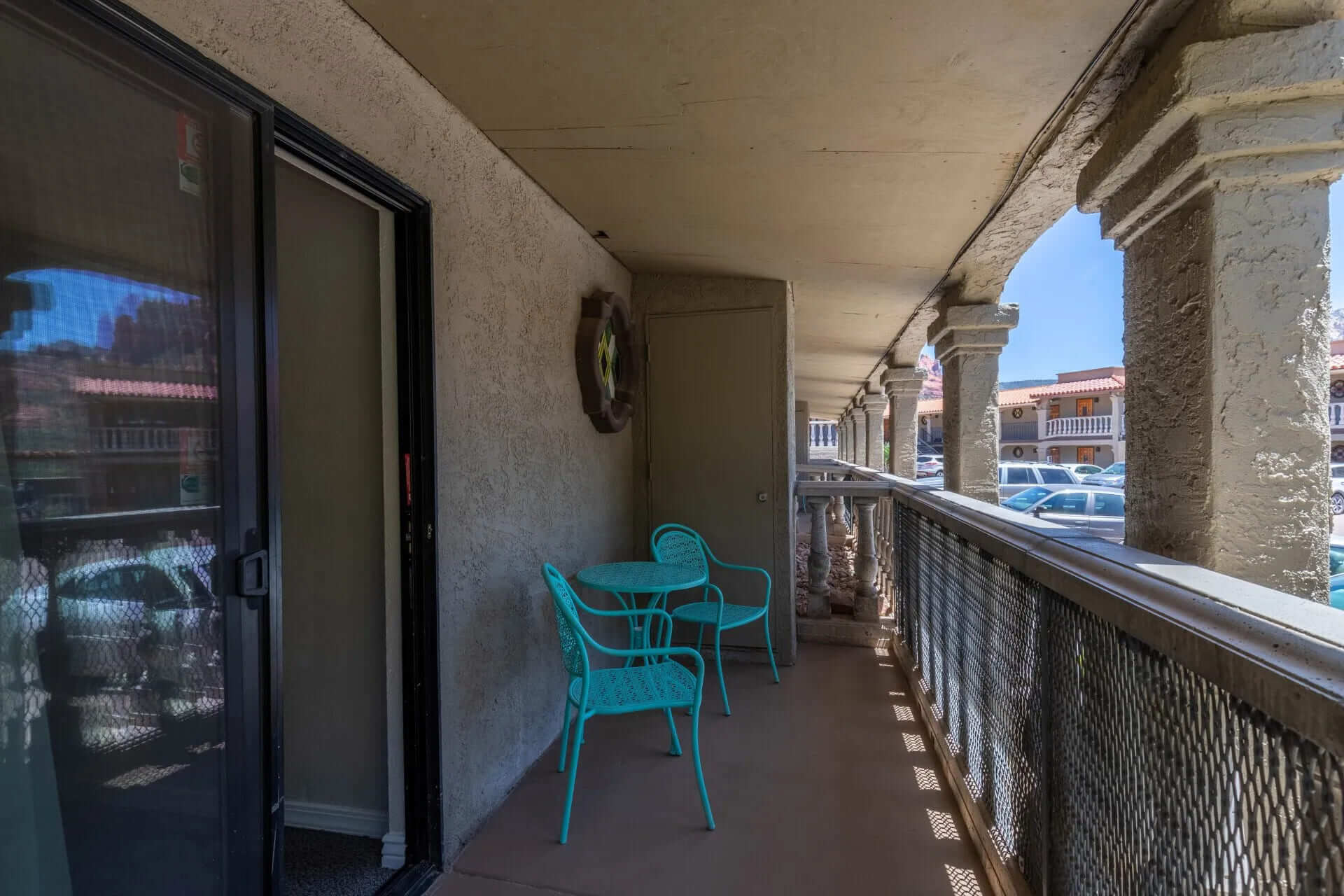 A balcony with a table and chairs